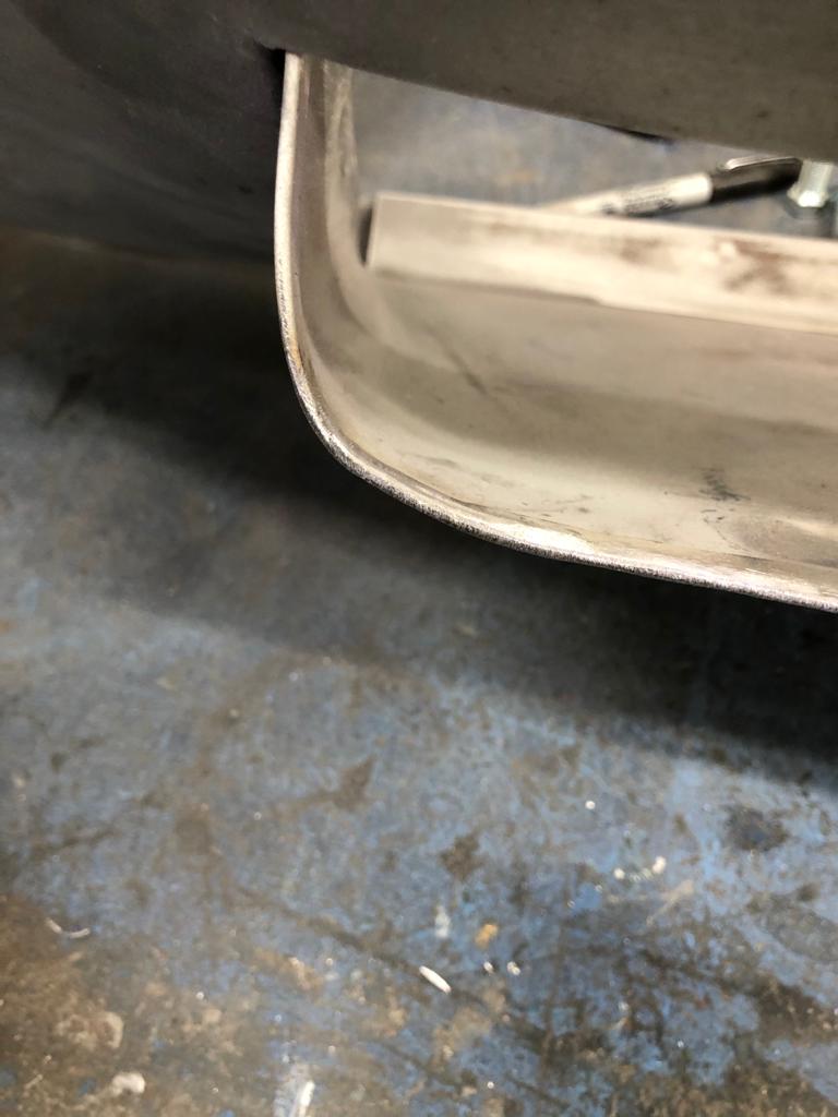 26052021 White jaguar etype roadster inconsistencies in the front over riders that needed addressing to obtain symmetry and leading the spot welded joints on the shell 38 1