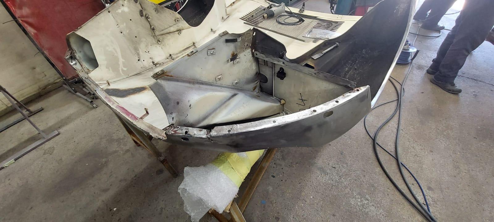 03062021 White etype bonnet rubbed and primed. wheel arch sttripped and undersealed 11 1