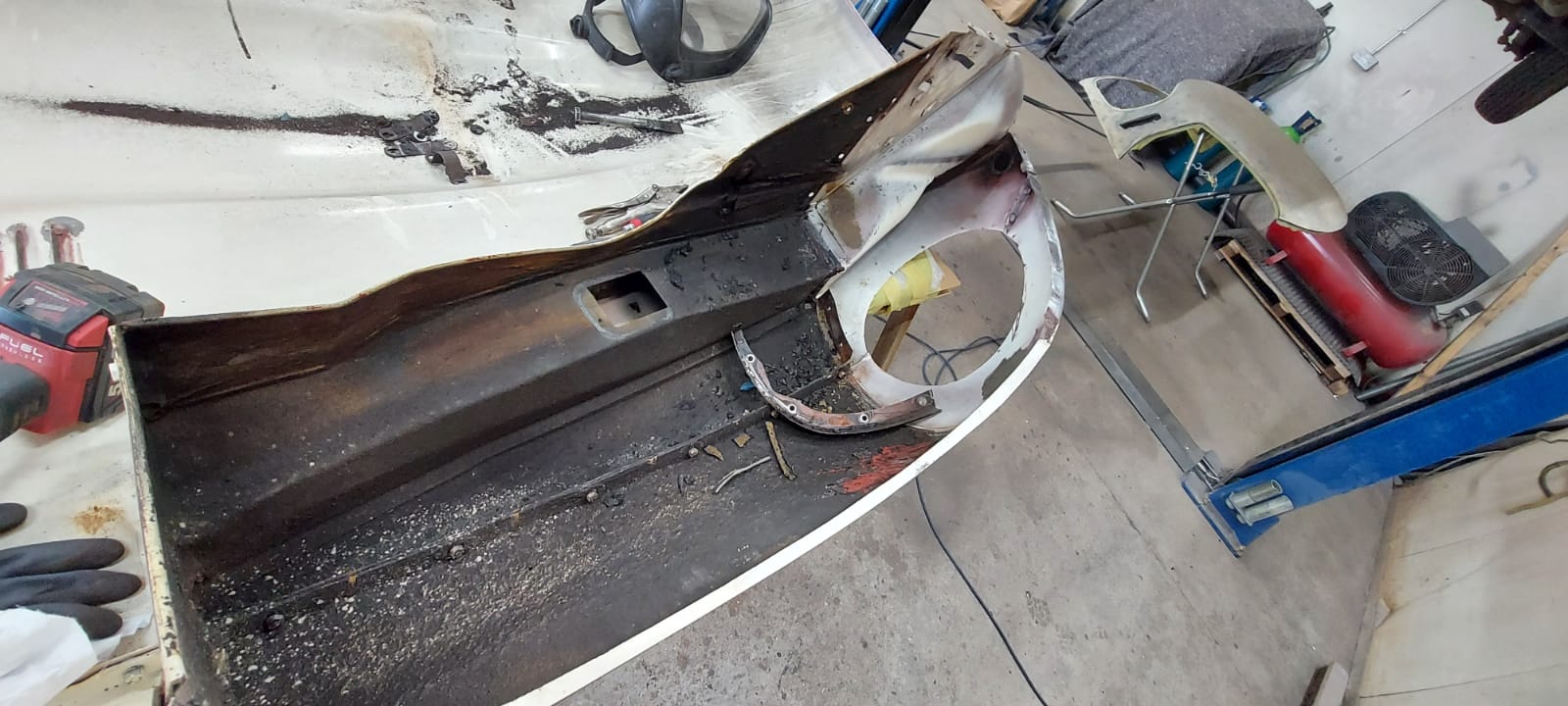 03062021 White etype bonnet rubbed and primed. wheel arch sttripped and undersealed 12 1