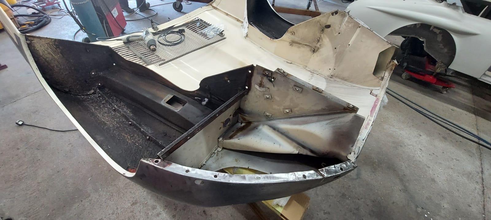 03062021 White etype bonnet rubbed and primed. wheel arch sttripped and undersealed 7 1