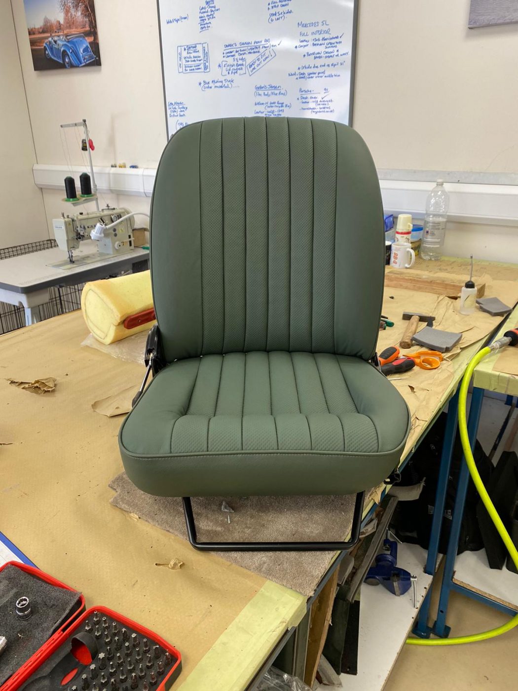 17062021 Jag E Type whitecutting headrest hole in seat squab coverfitting chrome trim into place 1 1