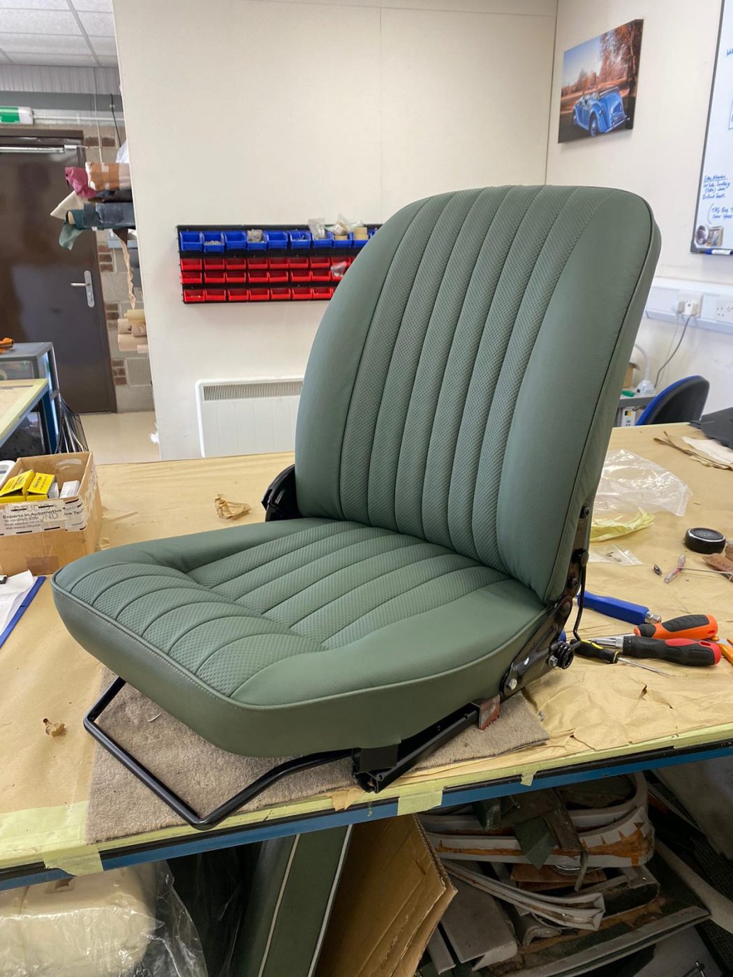 17062021 Jag E Type whitecutting headrest hole in seat squab coverfitting chrome trim into place 11 1