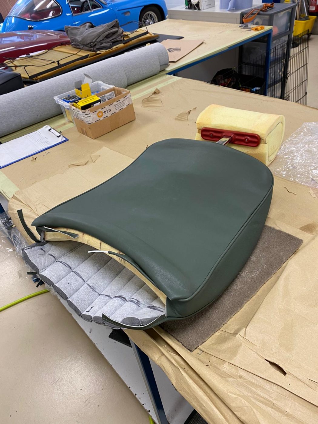 17062021 Jag E Type whitecutting headrest hole in seat squab coverfitting chrome trim into place 5 1