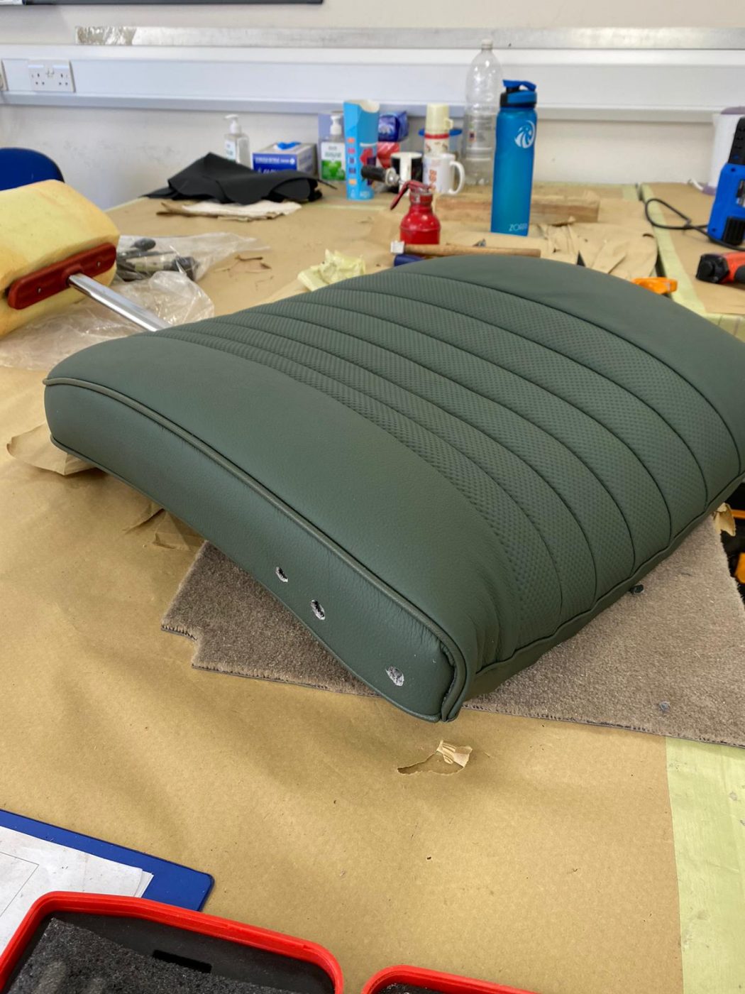 17062021 Jag E Type whitecutting headrest hole in seat squab coverfitting chrome trim into place 7 1
