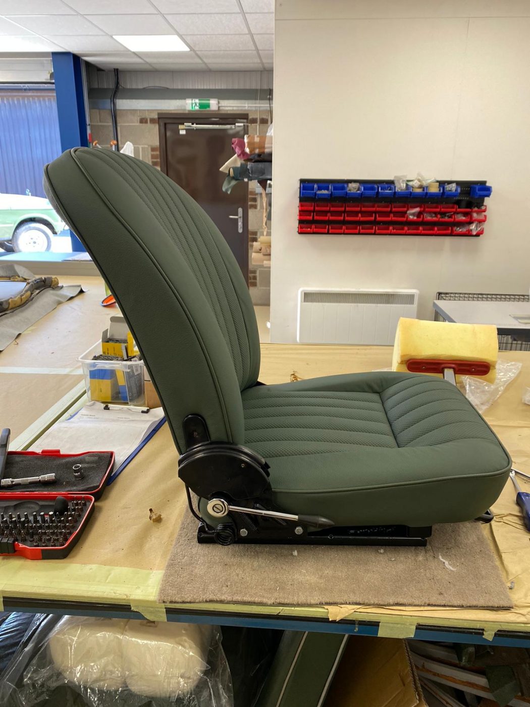 17062021 Jag E Type whitecutting headrest hole in seat squab coverfitting chrome trim into place 9 1