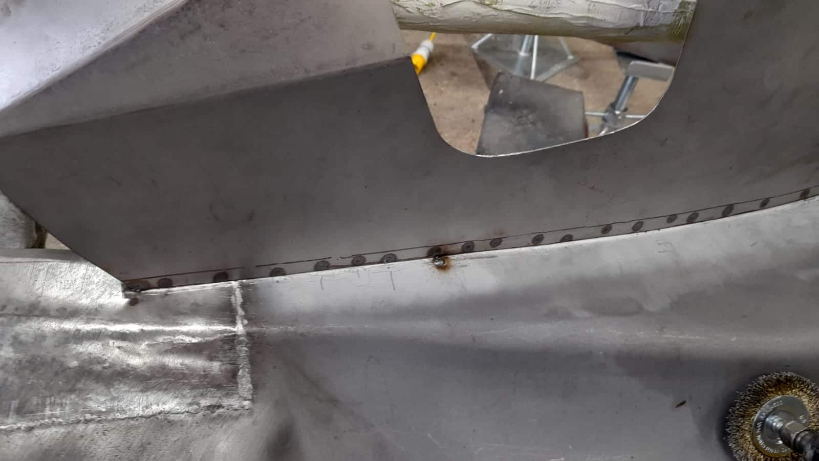 1951 Yellow Riley RMB wing surface corrosion reoval with grinder 6 1